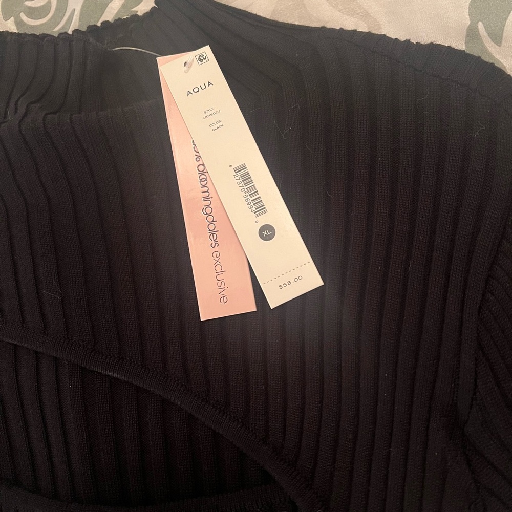 Black long-sleeved rib knit bodysuit with keyhole opening. NWT